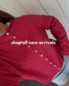 woman in pink and red striped sweater with "shop new arrivals" text
